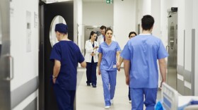 Doctors walking through a hospital hallway.