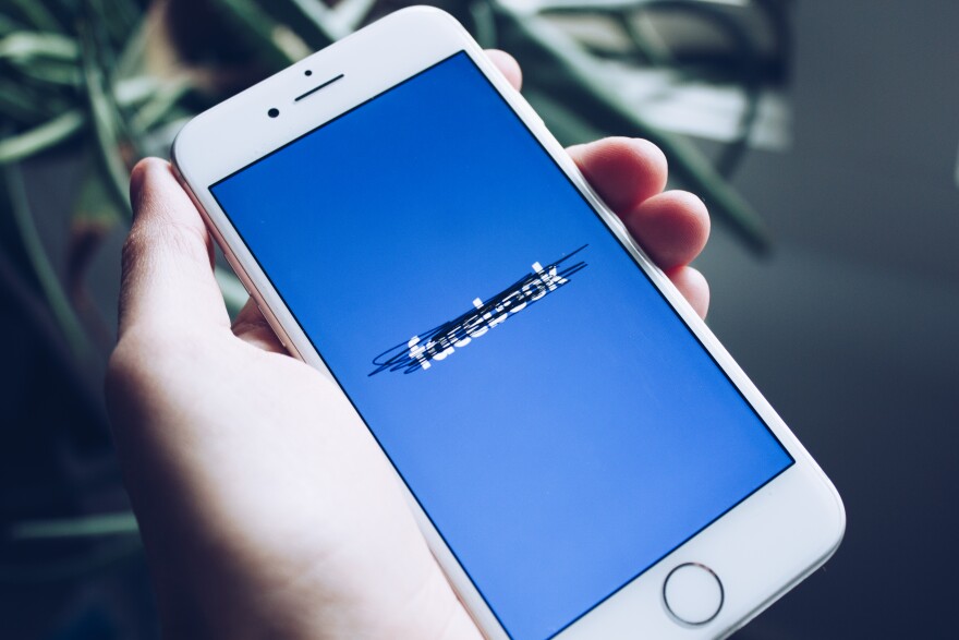 photo of iPhone with facebook app on it