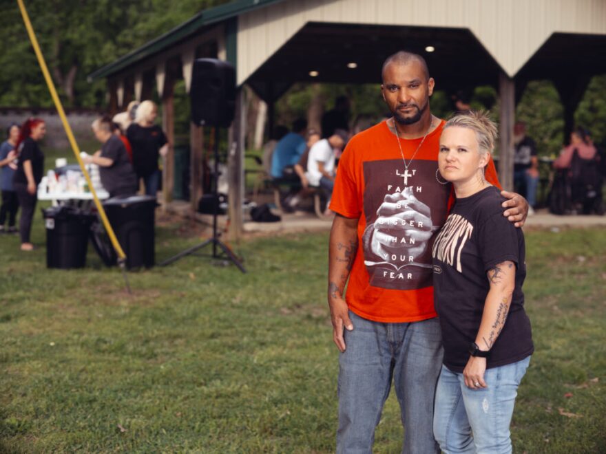 Zachary and Jennifer Banks pause during a community meal provided by Abundant Life Church at Gish Park in Central City, April 27, 2025.