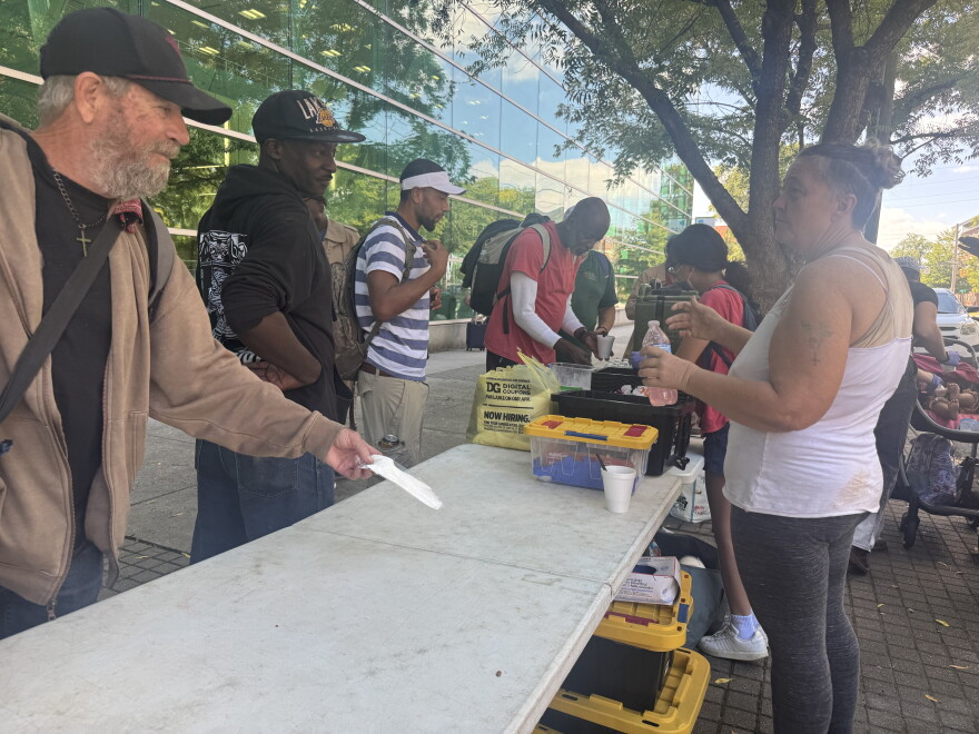 People line up for meals and beverages outside Richland Library Main in Columbia.