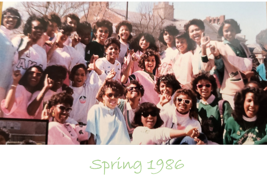 The Alpha Kappa Alpha sorority class of 1986 are photographed at The Yard, one of the main quadrangles on the campus of Howard University. Most of the women wear pink T-Shirts.