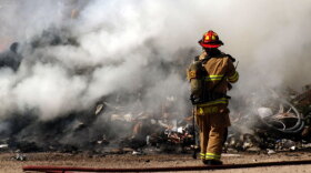 Firefighter putting out fire Spotlight