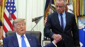 President Donald Trump, left, shakes the hand of Health and Human Services Secretary Robert F. Kennedy Jr. during a meeting to sign an executive order about vaccines Monday in the Oval Office of the White House.