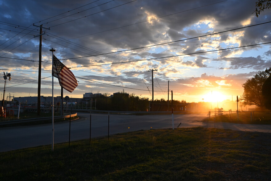 A cloud of dust is kicked up into the sunlight after a vehicle passes down West Smith Ferry Road.
