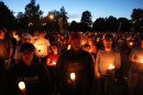 FILE - Carly Jenkins, left, and Alex Thomson, center, pay their respects alongside others during a vigil for Charlie Kirk on Sept. 12, 2025, in Provo, Utah. (AP Photo/Lindsey Wasson, File)