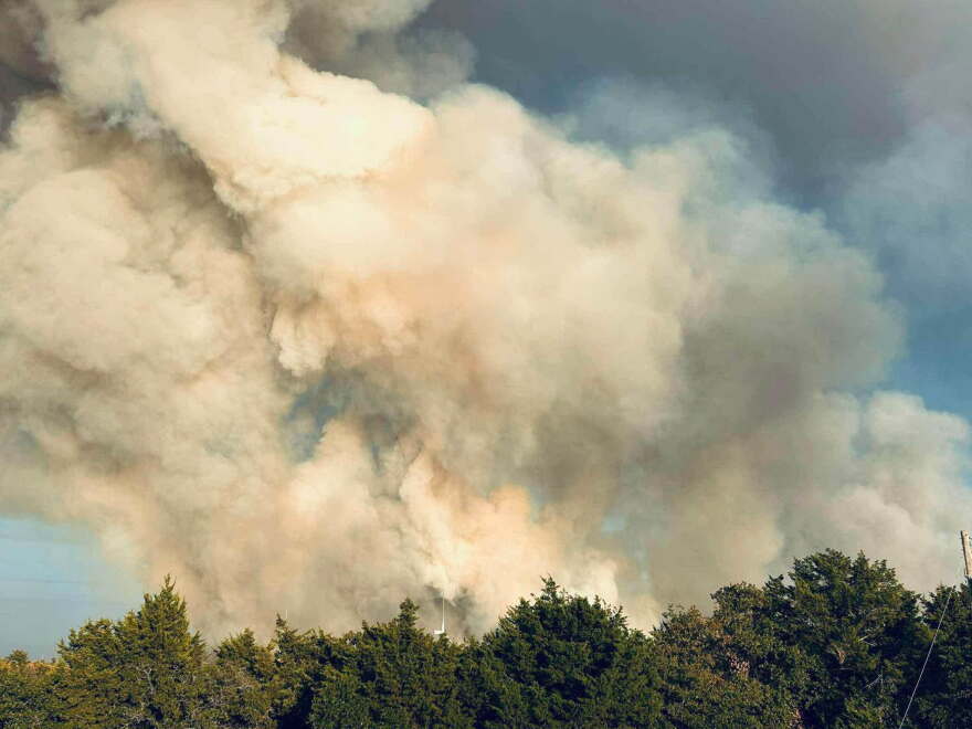 Smoke billows above the treetops in Caddo County.