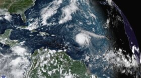 This satellite image provided by the National Oceanic and Atmospheric Administration shows Hurricane Sam, just right of center, in the Atlantic Ocean, Monday, Sept. 27, 2021, at 1920 Zulu (3:20 p.m. ET). Sam is a powerful Category 4 storm but it poses no threat to land as it loops northward in the Atlantic, according to the U.S. National Hurricane Center. (NOAA via AP)