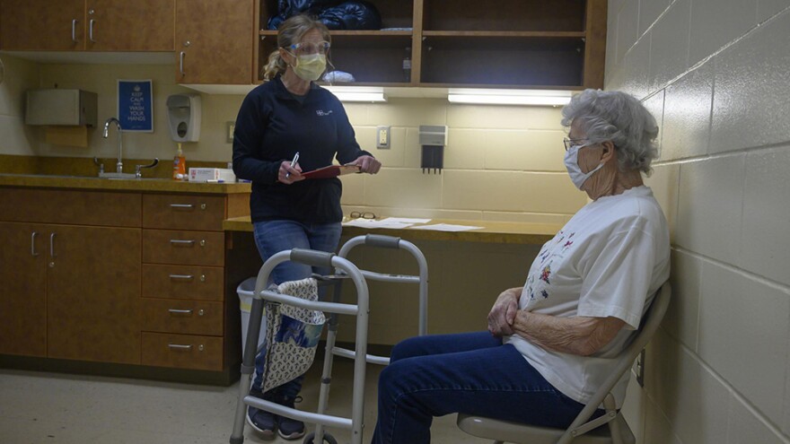 Nurse Tammy Miller asks Beverly Gerard, 92, of Beverly, Iowa, questions before administering her first dose of the Moderna COVID-19 vaccine on Feb. 1. Gerard secured an appointment at the Tama County Public Health Department clinic in through her niece.