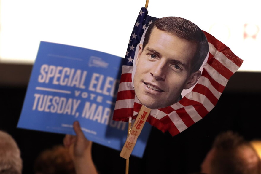 Supporters of Conor Lamb, the Democratic candidate for the March 13 special election in Pennsylvania's 18th Congressional District hold signs during his election night party in Canonsburg, Pa., Wednesday, March 14, 2018. Rattled Republicans were hit with the reality check Wednesday in the startling strong performance of a fresh-faced Democrat deep in Trump country. 
(AP Photo/Gene J. Puskar)