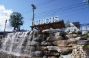 A sign reading "DuBois" above a rock waterfall. This display is on East DuBois Ave.
