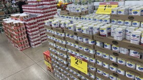 Shoppers wend their ways amid displays of cranberry sauce, green beans and soups set up for Thanksgiving Day feasts in a grocery store Tuesday, Nov. 16, 2021, in southeast Denver.