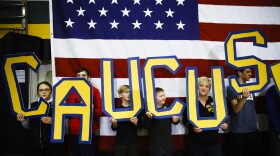 Attendees hold letters that read "CAUCUS" during a campaign event for Democratic presidential candidate and former South Bend, Ind., Mayor Pete Buttigieg in Iowa earlier this month.