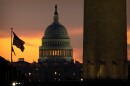 The base of the Washington Monument and the dome of the U.S. Capitol are seen at dawn on Wednesday, Oct. 1, 2025, in Washington.