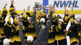 Boston Pride players cheer as coach Paul Mara hoists the NWHL Isobel Cup trophy after the team's win over the Minnesota Whitecaps in the championship hockey game in Boston, on Saturday, March 27, 2021. Organizers announced plans on Friday, June 30, 2023, to launch a new women’s professional hockey league in January that they hope will provide a stable, economically sustainable home for the sport's top players for years to come. The agreement ends a long standoff between the seven-team Professional Hockey Federation (PHF) and the PWHPA.