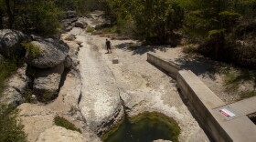 The water in Jacob's Well is at its lowest level in memory, in August 2023. Usually, it gushes into the bed of Cypress Creek, which is currently dry.