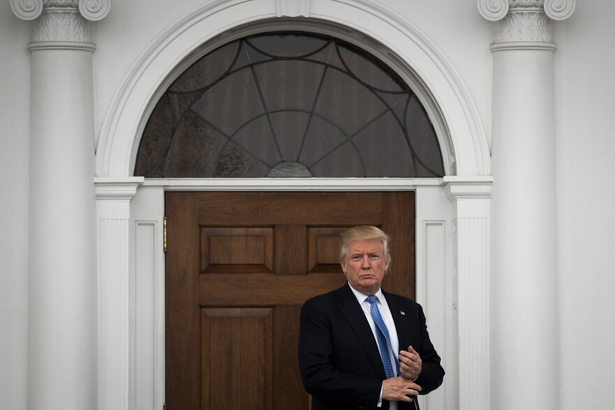 President-elect Donald Trump stands outside the clubhouse following his meeting with Peter Kirsanow, an attorney and member of the U.S. Commission on Civil Rights, at Trump International Golf Club, Sunday in Bedminster, N.J.