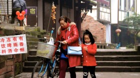 Mother and child commuting to school and work in Pingle "ancient town" in Sichuan Province, China