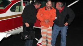 Police bring Taylor into custody on Sunday.