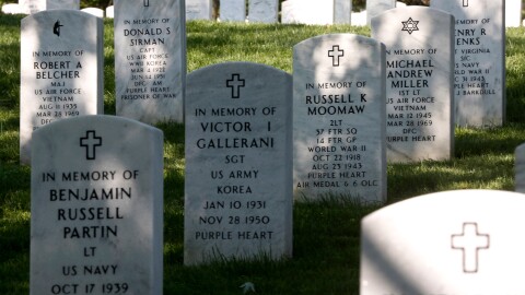 FILE - Rows of gravestones stand at the Arlington National Cemetery in Arlington, Va., May 13, 2014.