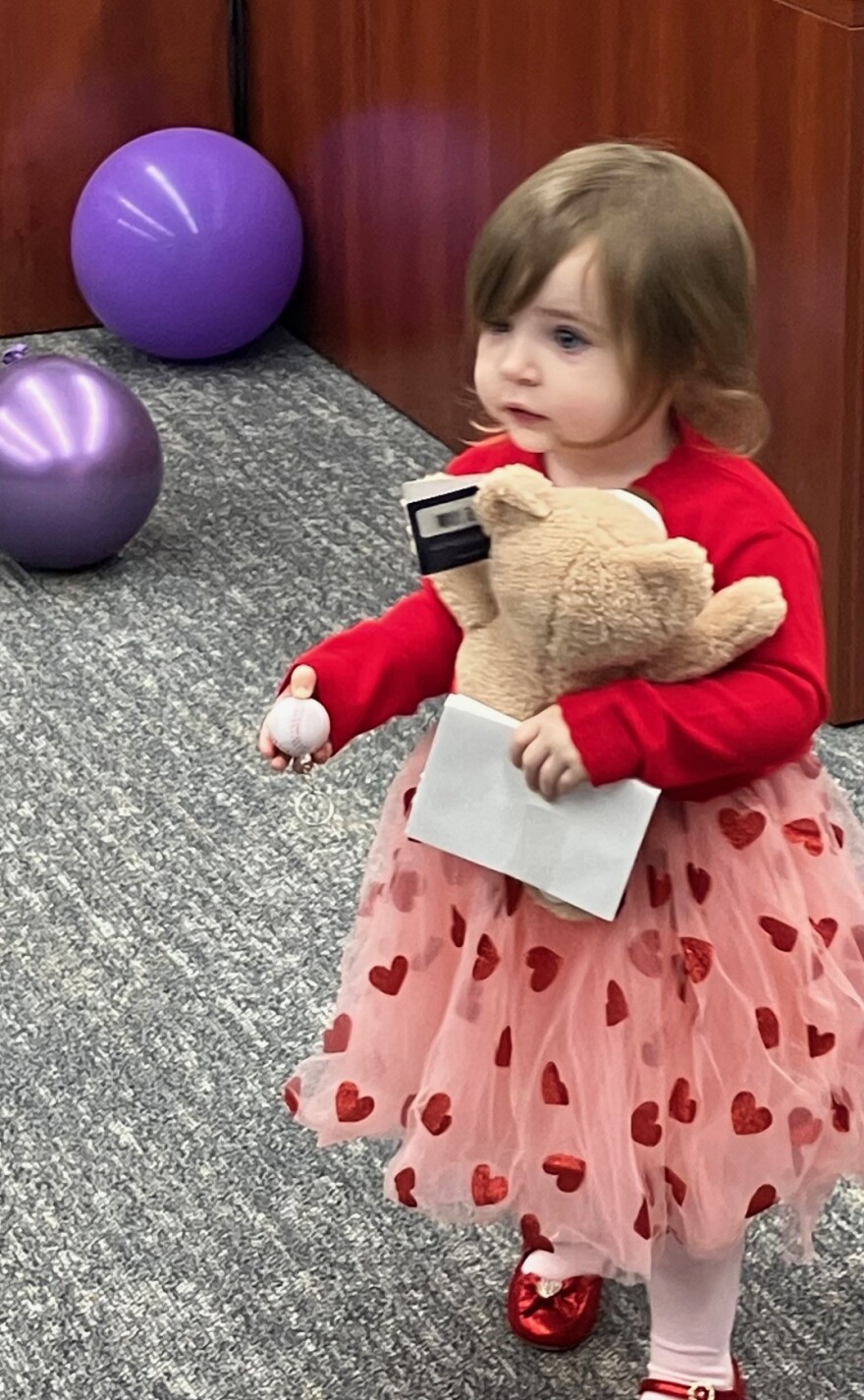 Newly adopted Stella, 2, with her new teddy bear Friday, Nov. 21, 2025.