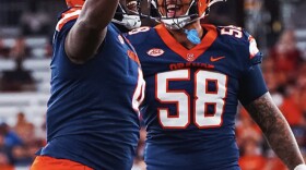 Two Syracuse defensive linemen celebrate a tackle during SU's win over Colgate.