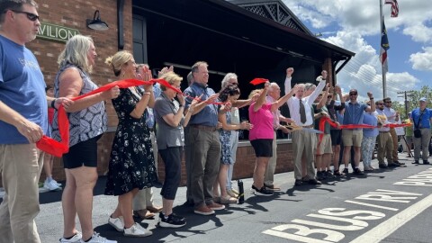 Officials from Henderson County and neighboring municipalities cut a ceremonial ribbon for the opening of the Ecusta Trail at the county's visitors center on July 18, 2025.