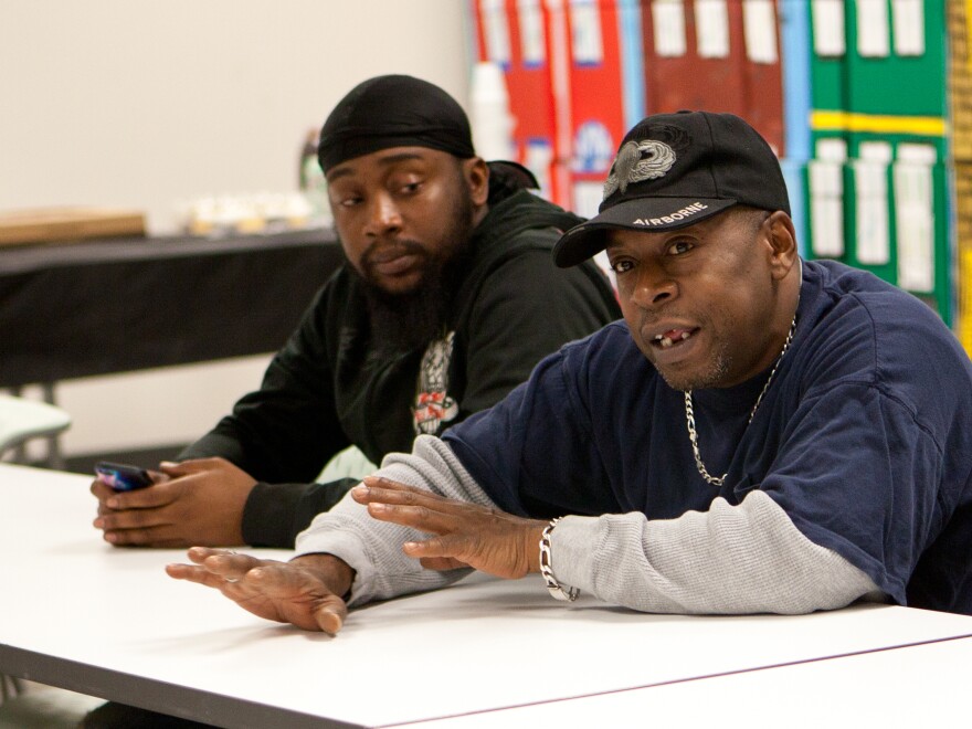 Harrelle Felipa (right) speaks during the Responsible Fatherhood meeting at the Center for Urban Families in Baltimore. His child support debt has accrued to $20,000 after he quit a job to be a stay-at-home dad.