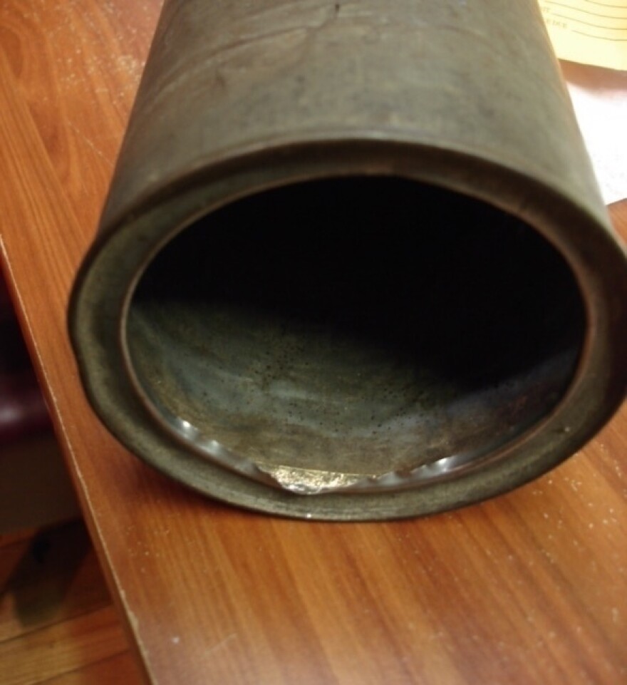 When jeweler Harmeet Singh examined the tin canister, he could tell there was metal hidden behind the lip, but you couldn't tell what it was. "Is it really gold or not — is it just a piece of lead to make it feel heavy?" he remembers wondering. He worked to remove the metal with a minimum amount of harm to the canister.