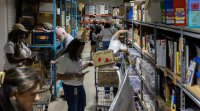 Educators scan shelves of materials during the reopening of The Welman Project at their new headquarters on May 19, 2026. Teachers have access to a variety of materials, books, games and furniture.