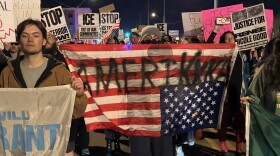 Protesters holding signs march down Seventh Street in Phoenix on Thursday, Jan. 8, 2026.