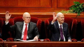 FILE - President Russell M. Nelson, right, raises his hand during a sustaining vote with his counselor, Dallin H. Oaks, left, during The Church of Jesus Christ of Latter-day Saints' twice-annual church conference Oct. 5, 2019, in Salt Lake City.