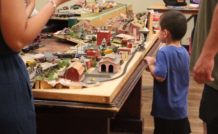 Young child admiring a portion of the model train exhibit set up by the Abilene Society of Model Railroaders as part of the Abilene Railroad Festival. Photo by Allison Diaz.