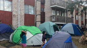Children standing around the tents. (Kate Payne/Iowa Public Radio)