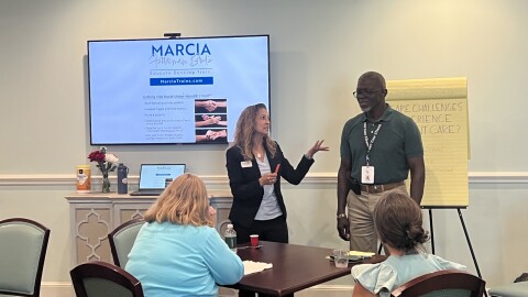 Marcia Brodie (left), a Norfolk-based dementia caregiver educator, leads a training on communication strategies for families and care staff working with people living with dementia.