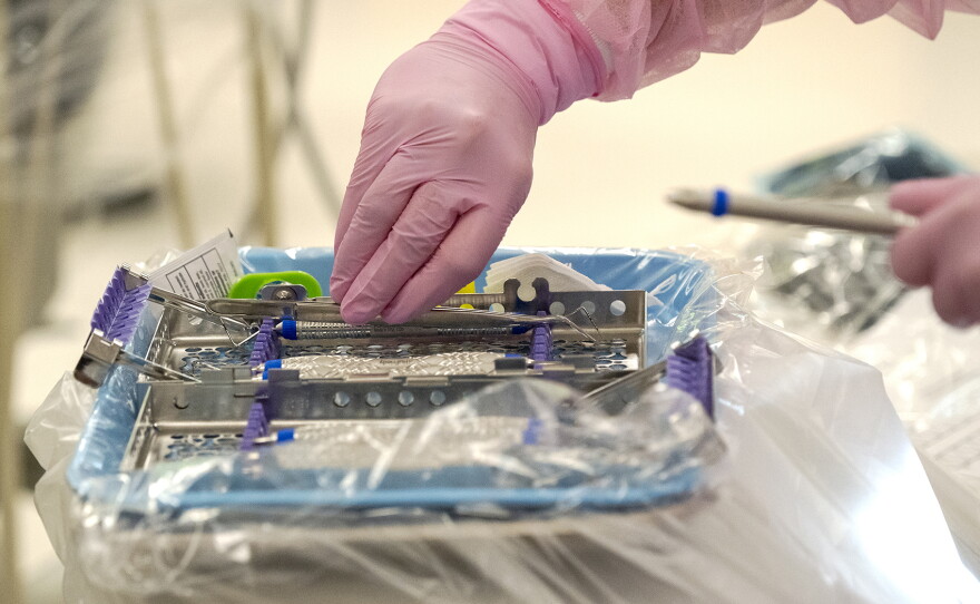 Tycee Thivierge organizes equipment while working on a patient's teeth through part of an NIC training program on Thursday, Oct. 1 at 450 11th Ave in Lewiston.