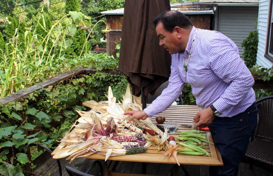 Taylor Keen sorts through the varieties of corn and other crops he has harvested from his backyard farm.