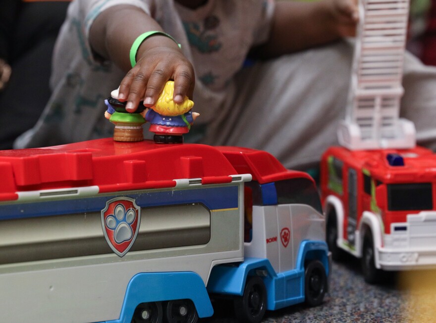 Ayana Chealey plays with a child at Monroe County Court's, Children’s Center in the Hall of Justice (Room 300), providing child care for families navigating the court system. The center is open from 9 a.m. to 5 p.m. for children ages 6 weeks to 12 years and is operated by Skies the Limit Academy, offering a safe, supervised play space while guardians attend to legal matters.
