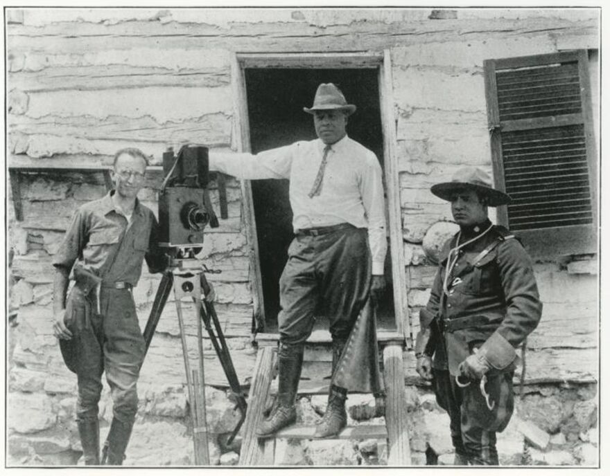 Oscar Micheaux (center) with an actor and possibly a crew member