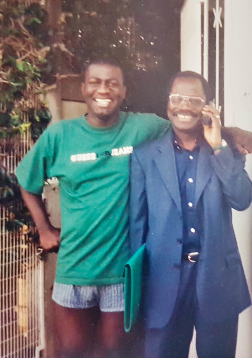 Carl Manlan at 22 with his dad the doctor, Kassi Manlan, in a photo from 2000. Kassi died the next year.