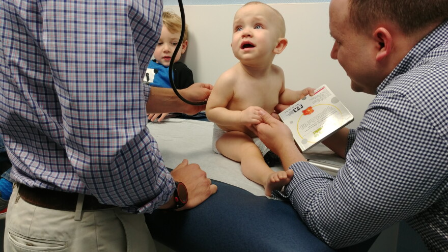 One year old Eleanor holds the new book she received from Dr. David Tayloe during her check up. The New Bern clinic gives books to kids at each of their well visits from six months to five years of age, as part of the Reach Out And Read program.