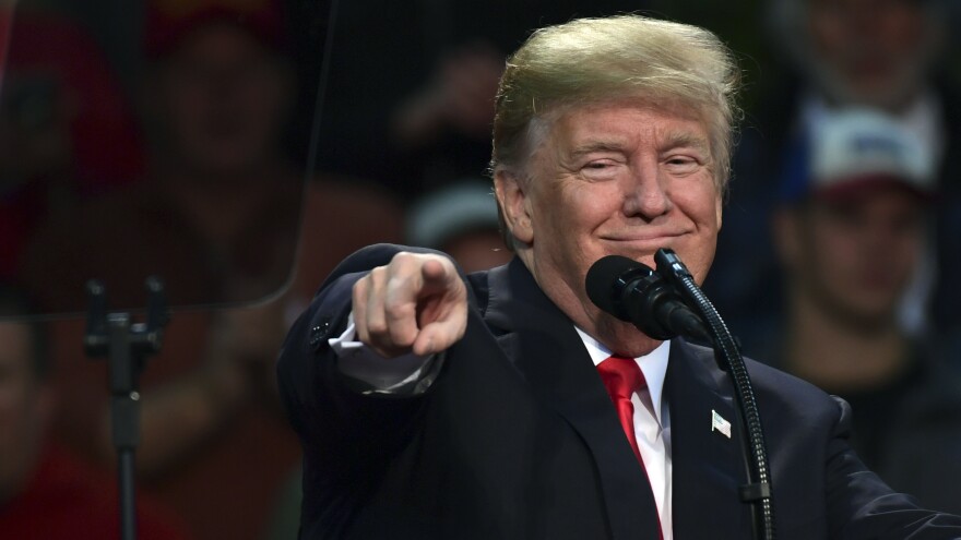 President Trump points out a supporter of Roy Moore, the embattled Alabama Republican Senate candidate, as he speaks at a campaign-style rally in Pensacola, Fla., Friday.