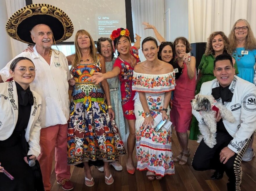 President Illine Davila poses with a mariachi band and members during a membership meeting and luncheon.