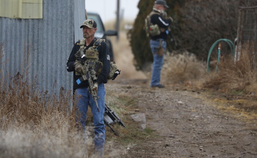 Members of the Real 3%ers Idaho stand watch during a convoy protection drill in western Idaho in January.