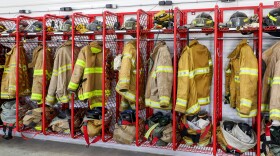A row of firefighters’ equipment hang at the ready at a fire station. The turnout gear often contains PFAS — a class of chemicals that add resistance to water, oil and heat but that can have adverse health effects.
