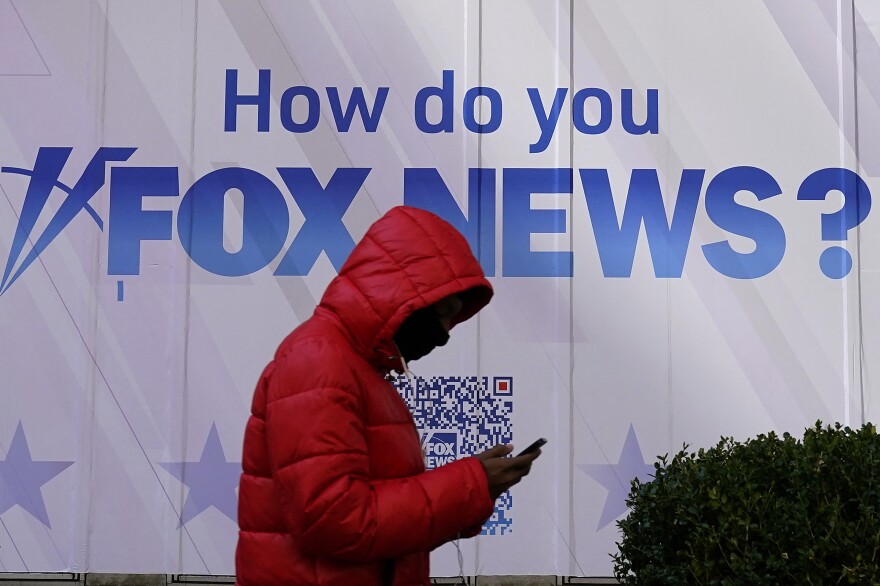 A person walks past the Fox News Headquarters at the News Corporation building in New York City last month. Dominion Voting Systems is suing Fox News and parent company Fox Corp. over election fraud claims that Fox aired in 2020 and 2021.
