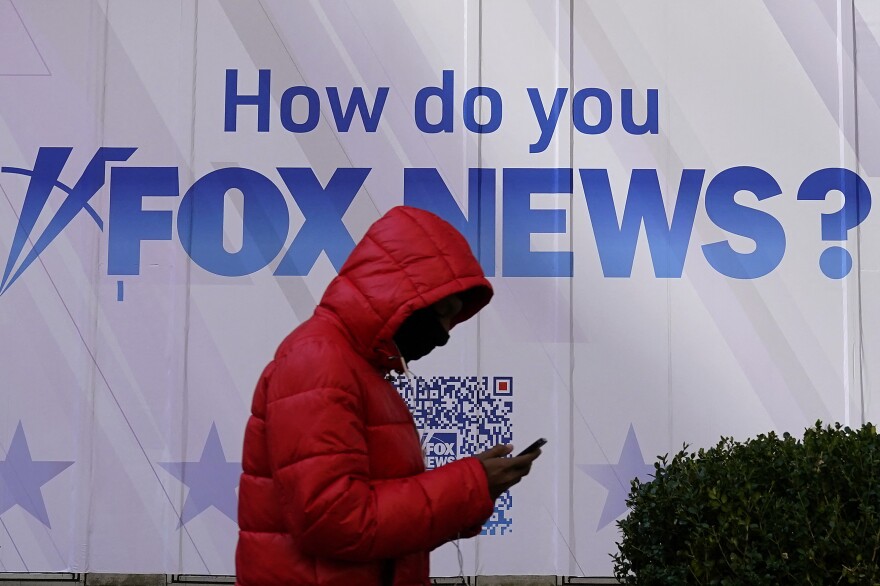 A person walks past the Fox News Headquarters at the News Corporation building in New York City last month. Dominion Voting Systems is suing Fox News and parent company Fox Corp. over election fraud claims that Fox aired in 2020  and 2021.