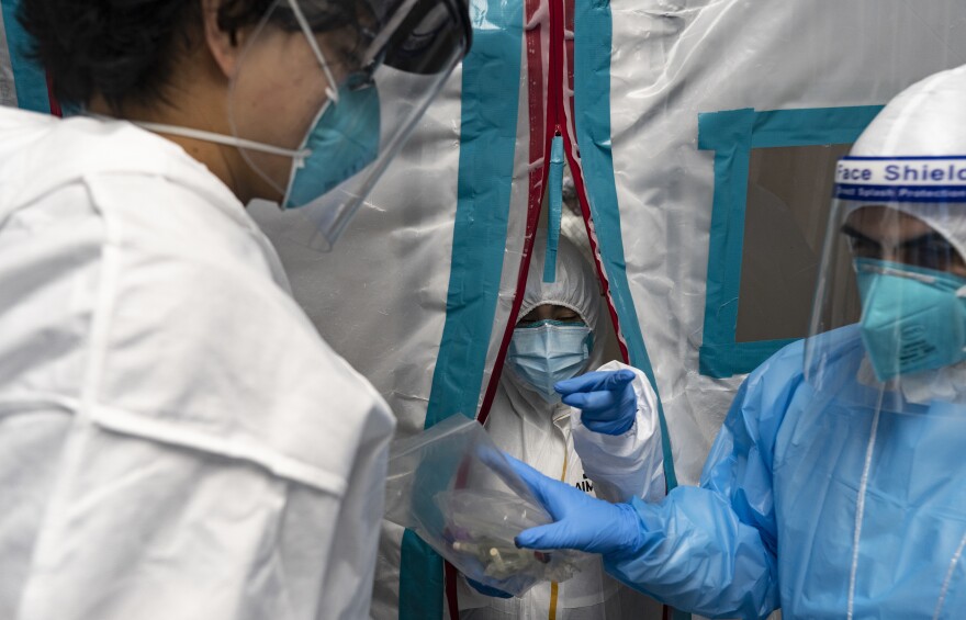 Medical staff members wear protective gear while working at the COVID-19 Intensive Care Unit at United Memorial Medical Center in Houston on Sunday.