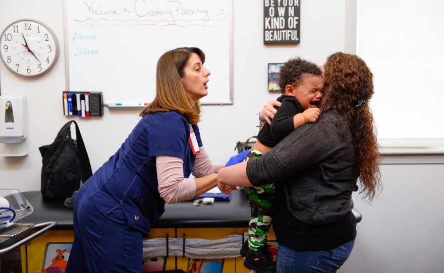 Kelly (right) comforts her son after his hepatitis vaccination at the Children's Health Center in Reading, Pa. The baby's birth motivated her to do whatever it took to avoid relapsing into addiction, she says. "I was in love with him."