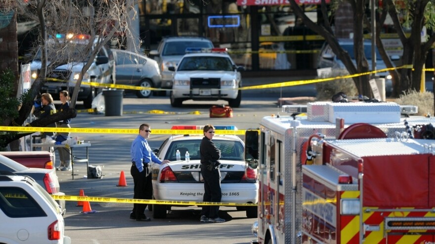 Police cordon off the shopping center where U.S. Rep. Gabrielle Giffords  (D-AZ) and several others were shot during an event in front of a Tucson grocery  store on Saturday.