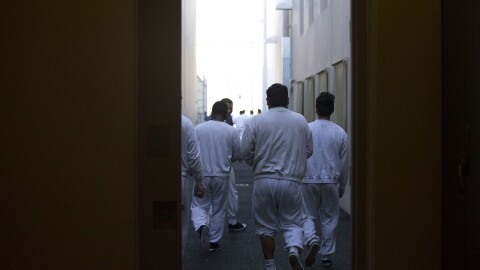 Detainees walk toward the outdoor recreation area on Tuesday, Sept. 10, 2019, at the Northwest ICE Processing Center in Tacoma.